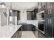 Modern kitchen with stainless steel appliances, a center island, and white backsplash at 2990 S Juliet Ct, Strasburg, CO 80136