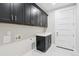 Functional laundry room with cabinetry and countertops at 2990 S Juliet Ct, Strasburg, CO 80136