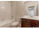 This bathroom features a shower-tub combination and a vanity with dark wood cabinets at 4783 S Wenatchee Cir, Aurora, CO 80015