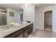 Spacious bathroom with double sink vanity, granite countertops, and tile flooring at 4783 S Wenatchee Cir, Aurora, CO 80015
