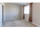 This bedroom has neutral walls, carpet and a window with patterned curtains at 4783 S Wenatchee Cir, Aurora, CO 80015
