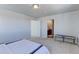 Bright bedroom with neutral colors, carpet floors, bench, walk-in closet and ensuite bathroom at 4783 S Wenatchee Cir, Aurora, CO 80015