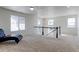 Large and bright bonus room features ample space for relaxation or entertainment, with neutral carpeting at 4783 S Wenatchee Cir, Aurora, CO 80015