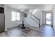 Dining area with a table set for two, adjacent to a staircase, and views of the front yard through a window at 4783 S Wenatchee Cir, Aurora, CO 80015