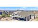 Aerial view of a backyard with a covered patio and mountain views beyond at 4783 S Wenatchee Cir, Aurora, CO 80015