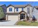 Charming two-story home with a well-maintained lawn, attached two-car garage, and attractive stone accents at 4783 S Wenatchee Cir, Aurora, CO 80015