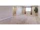Spacious living room with neutral colors, carpet floors, large window and pot plant at 4783 S Wenatchee Cir, Aurora, CO 80015