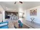 Open living area combining a well-equipped kitchen with barstool seating and a welcoming living room for seamless entertaining at 4783 S Wenatchee Cir, Aurora, CO 80015