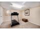 Cozy basement area featuring a treadmill and an attractive framed art piece over a leather storage bench at 16805 W 16Th Pl, Golden, CO 80401