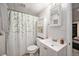 Bathroom featuring a white vanity, medicine cabinet, and a shower with a floral curtain at 16805 W 16Th Pl, Golden, CO 80401