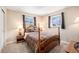 Inviting bedroom features a wooden bed frame, matching nightstands, and carpeted floors at 16805 W 16Th Pl, Golden, CO 80401