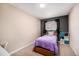 Cozy bedroom with a dark accent wall, carpeted floors, and a window view of the outdoors at 16805 W 16Th Pl, Golden, CO 80401