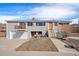 Charming home featuring a split-level design, garage, and quaint front porch seating area at 16805 W 16Th Pl, Golden, CO 80401