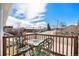 Inviting front porch featuring ornate green chairs and table, offering neighborhood views under a bright sky at 16805 W 16Th Pl, Golden, CO 80401