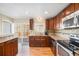 Kitchen features wood cabinets, granite countertops and stainless appliances, with a backyard view at 16805 W 16Th Pl, Golden, CO 80401