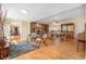 Spacious living room with hardwood floors and stone fireplace, seamlessly flowing into the dining area at 16805 W 16Th Pl, Golden, CO 80401