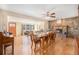 Open-concept living and dining area with hardwood floors, stone fireplace, and stylish furnishings at 16805 W 16Th Pl, Golden, CO 80401