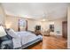 Large, bright bedroom features ceiling fan, wood floors, and closet at 16805 W 16Th Pl, Golden, CO 80401