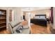 Comfortable main bedroom with hardwood floors has a chair, bookshelves and exterior access at 16805 W 16Th Pl, Golden, CO 80401