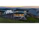 Beautiful backyard with a well-maintained lawn, wooden fence and a view of the mountains at sunset at 423 Rogers Way, Castle Rock, CO 80104