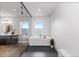 Bathroom featuring black honeycomb tile, modern tub, and a large vanity area near a seamless glass shower at 423 Rogers Way, Castle Rock, CO 80104