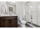 Modern bathroom with a glass-enclosed shower, stylish vanity, updated fixtures, and tiled flooring at 423 Rogers Way, Castle Rock, CO 80104
