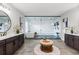 Luxurious bathroom featuring dual vanities, large mirrors, and a stunning glass-enclosed shower and tub area at 423 Rogers Way, Castle Rock, CO 80104
