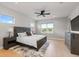 Comfortable bedroom featuring a king bed, soft rug, and plenty of natural light from a window at 423 Rogers Way, Castle Rock, CO 80104