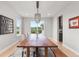 Spacious dining room with a large wooden table, stylish chairs, and a modern chandelier at 423 Rogers Way, Castle Rock, CO 80104