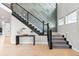 Inviting foyer with wood floors, a staircase with a dark wood banister, and geometric wall decor at 423 Rogers Way, Castle Rock, CO 80104