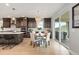 Open concept kitchen with dark cabinets, an island, dining area, and sliding glass doors to the deck at 423 Rogers Way, Castle Rock, CO 80104