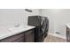 A spacious laundry room features a washing machine, dryer, and sink at 423 Rogers Way, Castle Rock, CO 80104
