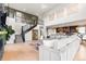 Bright living room showcasing a staircase, gray couch and an open concept to the kitchen and dining area at 423 Rogers Way, Castle Rock, CO 80104