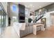 Open-concept living area with staircase, stone fireplace, large windows and comfortable seating at 423 Rogers Way, Castle Rock, CO 80104