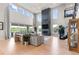 Bright and airy living room with a stone fireplace, large windows, and comfortable seating at 423 Rogers Way, Castle Rock, CO 80104