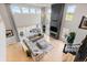 Spacious living room with high ceilings, a stone fireplace, and expansive windows for natural light at 423 Rogers Way, Castle Rock, CO 80104