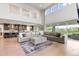 Open floor plan combines living area and kitchen, with large windows and a comfortable seating arrangement at 423 Rogers Way, Castle Rock, CO 80104
