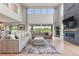 Living room boasts large windows, a stone fireplace, comfortable seating, and elegant decor at 423 Rogers Way, Castle Rock, CO 80104
