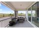 Relaxing covered patio area with wicker furniture and a view of the open field beyond at 423 Rogers Way, Castle Rock, CO 80104