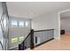 A naturally lit staircase features views and designer light fixtures at 423 Rogers Way, Castle Rock, CO 80104