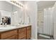 Bright bathroom featuring double sinks, wooden cabinetry, and a shower/tub combination at 23346 E 5Th Pl # 101, Aurora, CO 80018