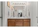 Bright bathroom featuring double sinks, wooden cabinetry, and a large mirror at 23346 E 5Th Pl # 101, Aurora, CO 80018
