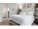 Bedroom with large bed, art and shelf decor at 23346 E 5Th Pl # 101, Aurora, CO 80018