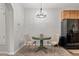 Dining area includes table and chairs under chandelier adjacent to black refrigerator at 23346 E 5Th Pl # 101, Aurora, CO 80018