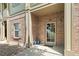 Charming entryway featuring a glass-paneled door, brick accents, and decorative potted plants at 23346 E 5Th Pl # 101, Aurora, CO 80018