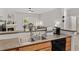 Kitchen sink area with stainless steel sink, wood cabinets, and natural light at 23346 E 5Th Pl # 101, Aurora, CO 80018