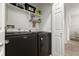 Well-organized laundry room features modern, black Maytag washer and dryer, plus plenty of shelving for storage at 23346 E 5Th Pl # 101, Aurora, CO 80018