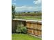 Expansive backyard view overlooking grassy field and mountain range in the distance at 2520 Canfield Ln, Erie, CO 80026