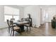 Elegant dining room with a large table and chairs, complemented by modern decor and ample natural light at 2520 Canfield Ln, Erie, CO 80026