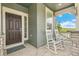 Inviting front porch with rocking chairs, offering a relaxing outdoor space with stylish stone pillars and trim at 2520 Canfield Ln, Erie, CO 80026